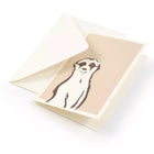 A minimalist greeting card with a warm beige background, featuring a simple, hand-drawn illustration of a meerkat in dark brown linework, standing upright with a calm, curious expression, tucked into a white envelope.