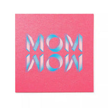 A playful greeting card with a textured pink background, showcasing “MOM WOW” in chunky, stylized letters with a light blue and white gradient and subtle halftone detailing.