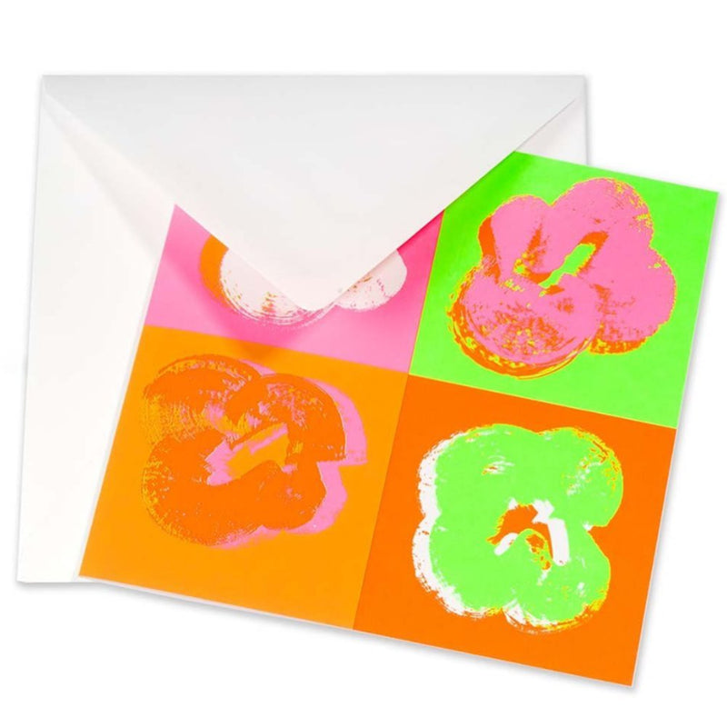 Greeting card with a striking pop-art design of four textured, painterly flowers arranged in a square layout, set against saturated neon backgrounds in pink, green, orange, and white, tucked into a white envelope.