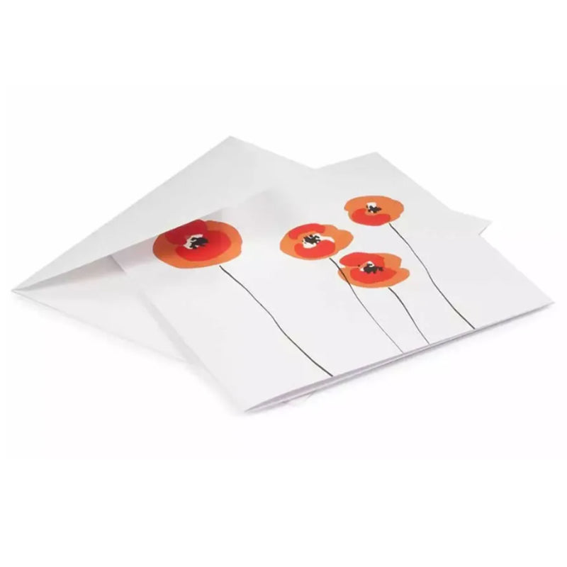 A greeting card partially tucked into a white envelope, featuring a delicate illustration of red and orange poppy flowers with loose, painterly shapes and fine linear stems.