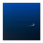 A minimalist greeting card with a deep blue gradient background, featuring a tiny white sailboat leaving a delicate trail across the open water.