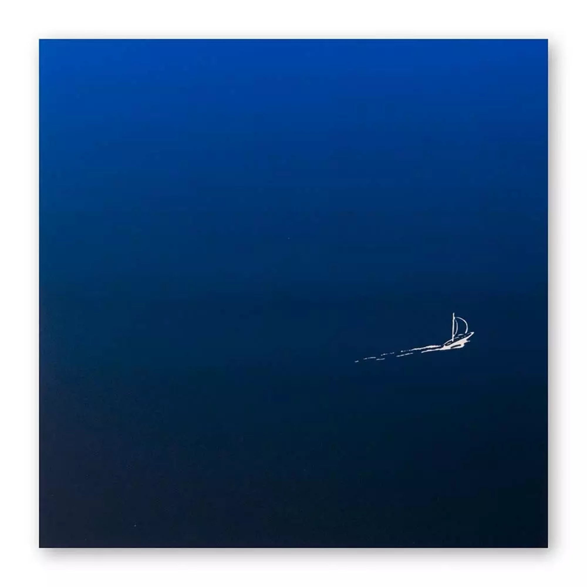 A minimalist greeting card with a deep blue gradient background, featuring a tiny white sailboat leaving a delicate trail across the open water.