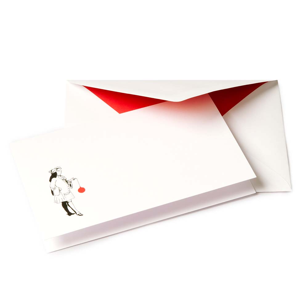 White Christmas card with a black illustration of a noble figure holding a large red Christmas ornament, paired with a red-lined envelope.