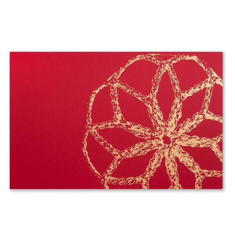 A Christmas card with a large golden bauble design on a bright red background.