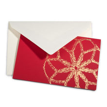 A Christmas card with a large golden bauble design on a bright red background, paired with a cream envelope.