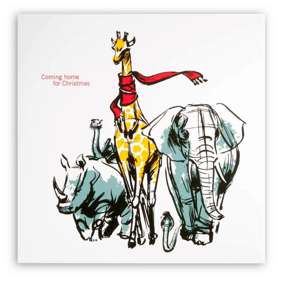 White Christmas card with an illustrated giraffe wearing a red scarf, walking alongside an elephant and a rhinoceros, with the text “Coming home for Christmas.”