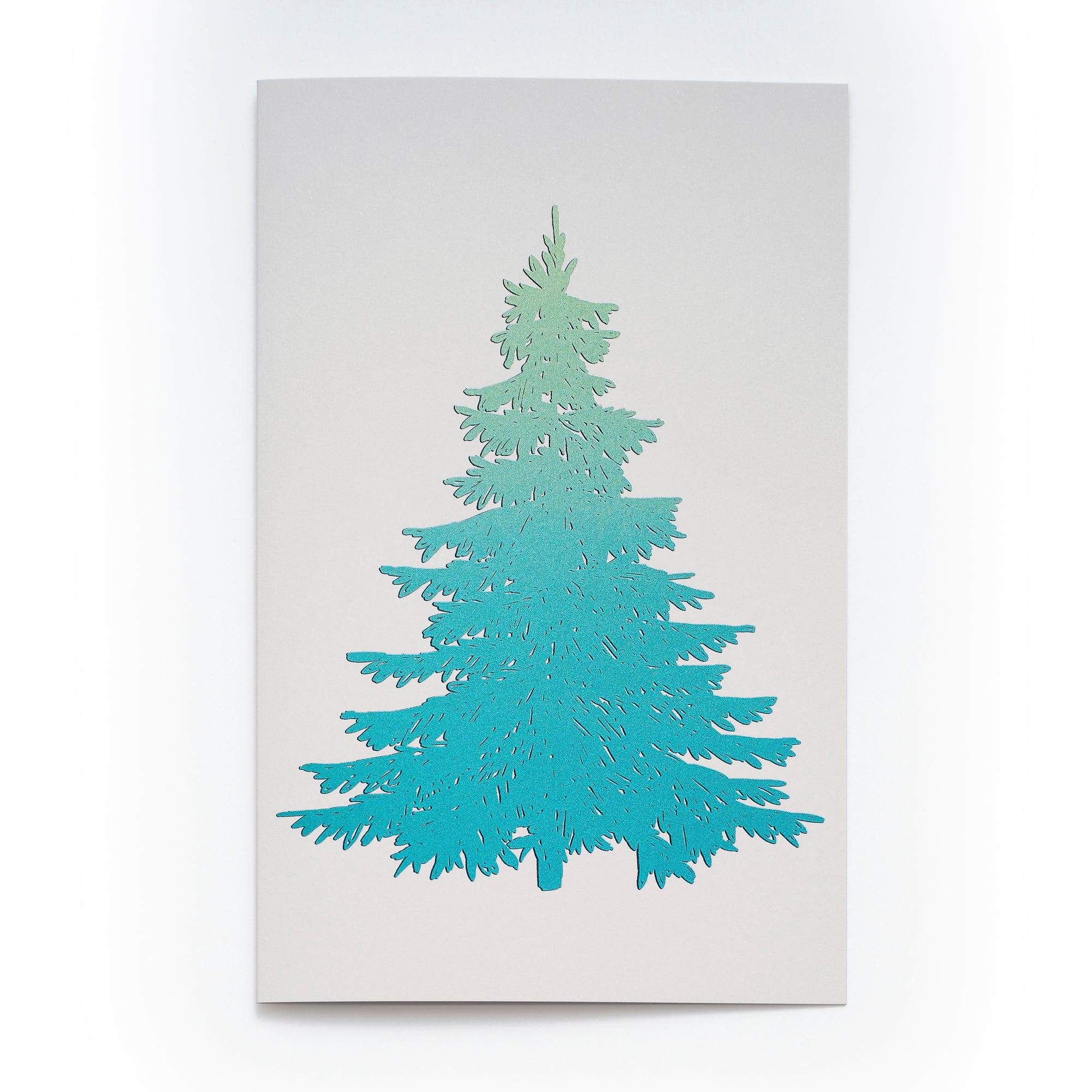 White Christmas card featuring a large stylized Christmas tree in shimmering blue foil.