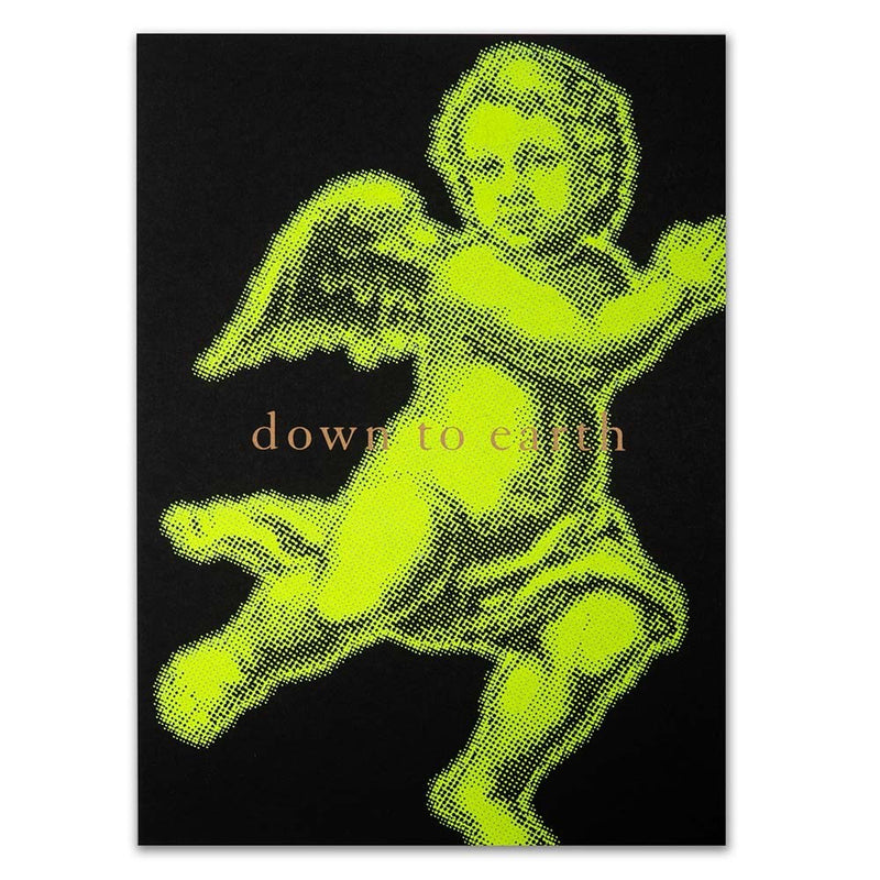 Christmas card with a bold neon yellow angel illustration on a black background, accompanied by the text 'down to earth'.