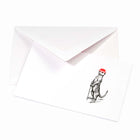 White Christmas card with a black illustration of a meerkat standing upright and holding a cane, wearing a red festive bowler hat, with a matching white envelope.
