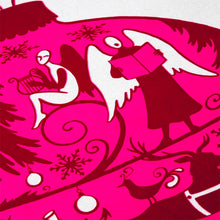 A close-up of a Christmas card with a bright pink ornament illustration filled with silhouettes of festive figures, animals, and decorations.