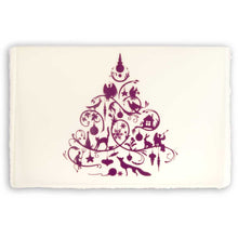 A cream-colored Christmas card with deckle edges, printed with a detailed purple ornamental design featuring festive silhouettes.