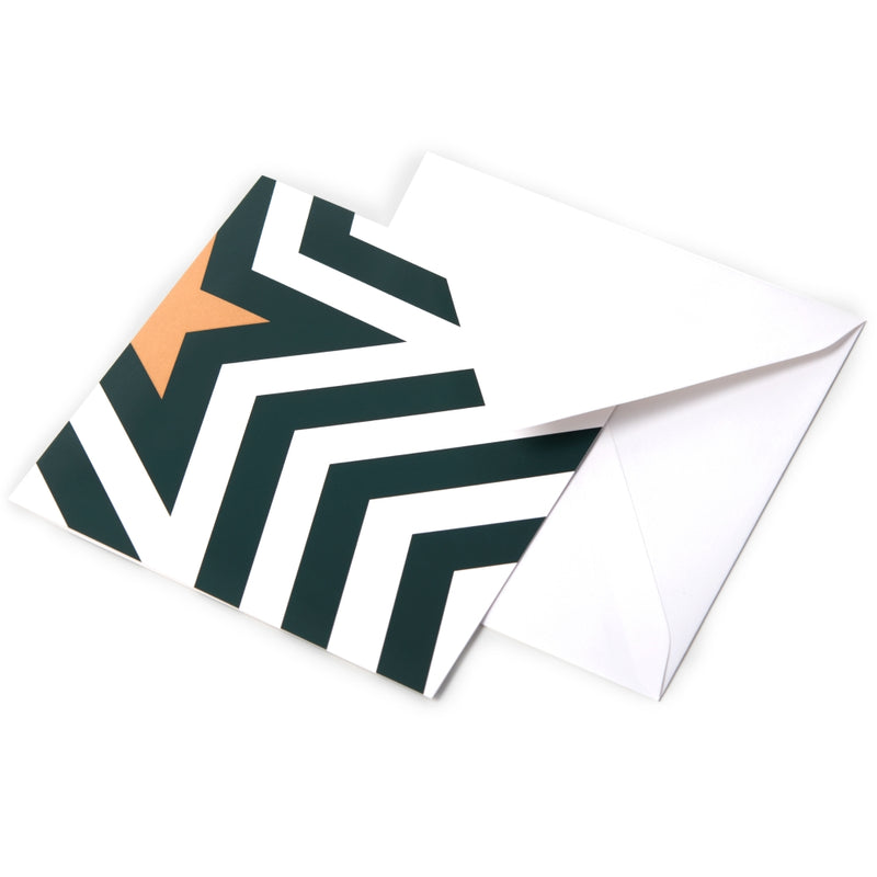 Christmas card featuring a bold zigzag pattern in dark green and white with a golden star forming a stylized Christmas tree, paired with a white envelope.