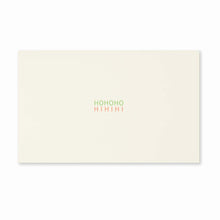 Minimalist cream-colored Christmas card with the words 'HOHOHO' in green and 'HIHIHI' in red printed in the center.