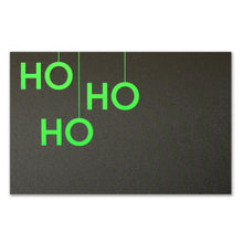 A black Christmas card with bold neon green letters arranged vertically to read "HO HO HO".