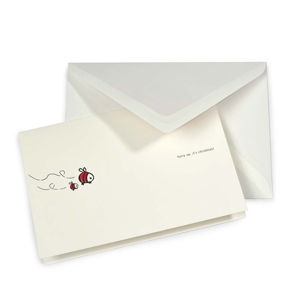 Whimsical cream Christmas card with two cartoon bees flying on the left and the text 'hurry up, it’s Christmas!' on the right, paired with a white envelope.
