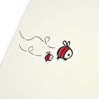 A close-up of a cream Christmas card with two cartoon bees flying on the left.