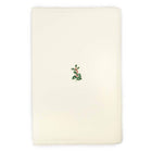 A cream-colored Christmas card with deckled edges, featuring a small holly sprig with green leaves and red berries in the center.