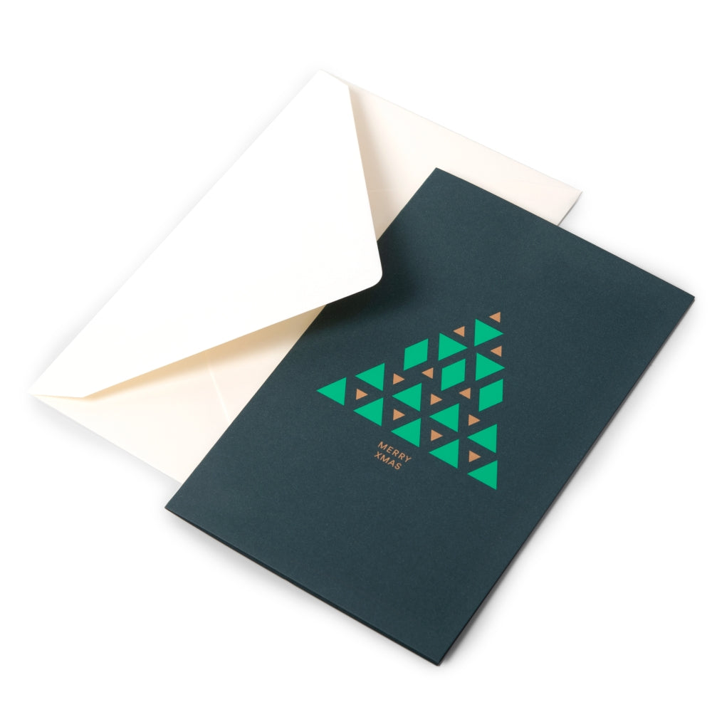 Modern dark green Christmas card with a geometric Christmas tree design made of green and gold triangles, reading "Merry Xmas" in gold, shown with a cream envelope.