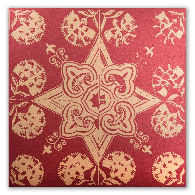 A Christmas card with a decorative golden star and floral pattern on a red background.