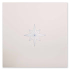 A minimalist Christmas card featuring a fine-lined blue star on a sandy beige background.