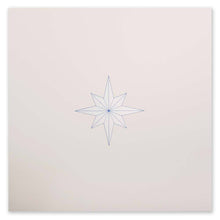 A minimalist Christmas card featuring a fine-lined blue star on a sandy beige background.