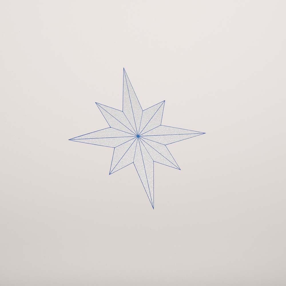 A close-up of a minimalist Christmas card featuring a fine-lined blue star on a sandy beige background.
