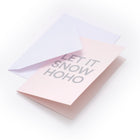 Light pink Christmas card with bold silver text reading 'LET IT SNOW HOHO,' accompanied by a plain white envelope.