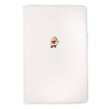 A cream-colored Christmas card with deckled edges, featuring a small illustration of Santa Claus in a red suit holding a sack of gifts.