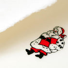 A close-up of a cream-colored Christmas card with deckled edges, featuring a small illustration of Santa Claus in a red suit holding a sack of gifts.