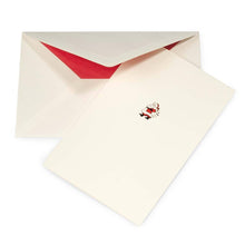 Minimalist cream Christmas card with a small Santa Claus illustration in red, black, and white, paired with a cream envelope lined in red.