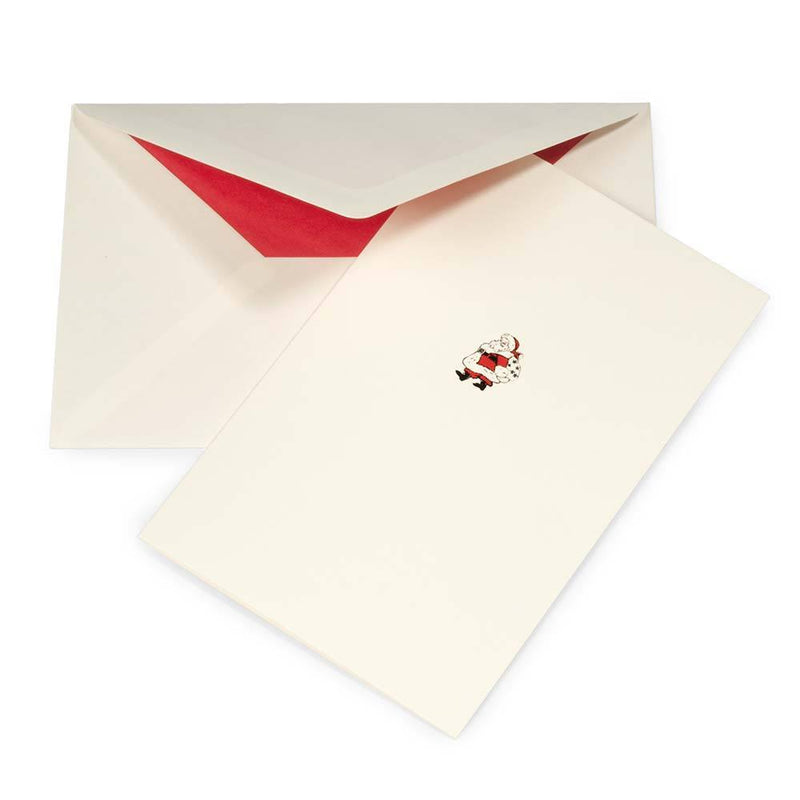 Minimalist cream Christmas card with a small Santa Claus illustration in red, black, and white, paired with a cream envelope lined in red.