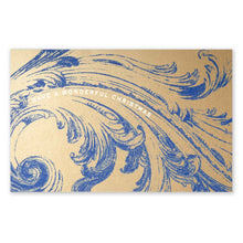 A brown kraft paper Christmas card decorated with an elaborate blue ornamental swirl pattern and the greeting "HAVE A WONDERFUL CHRISTMAS".