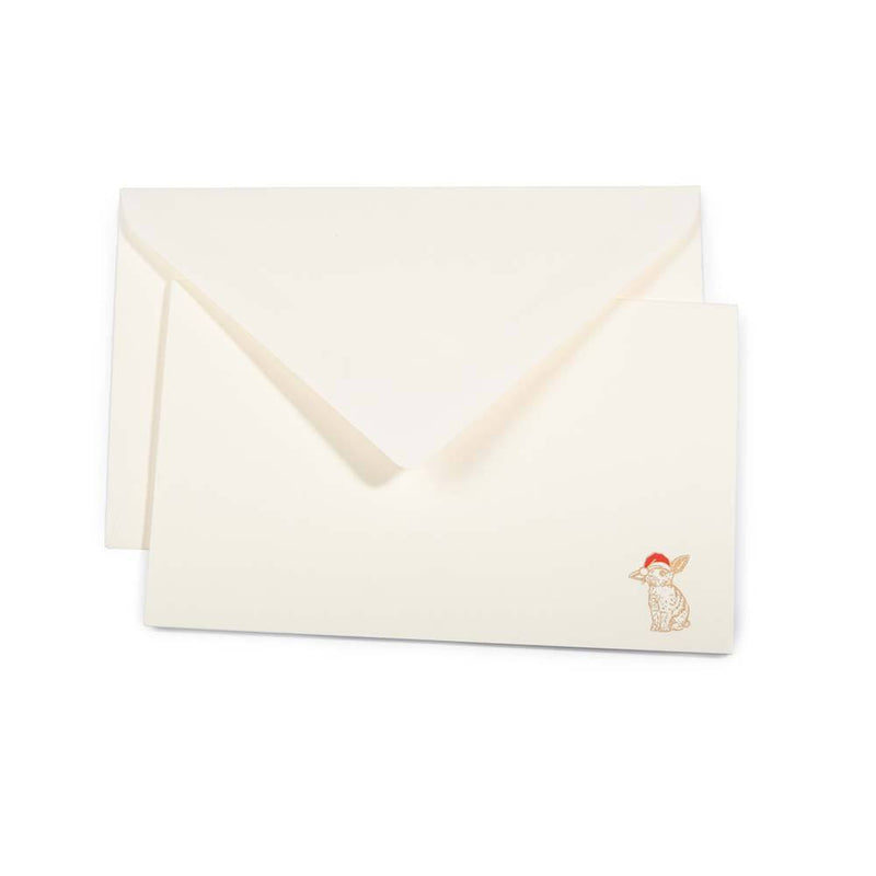 Minimalist cream-colored Christmas card with a small illustration of a rabbit wearing a Santa hat in the bottom right corner, paired with a matching cream envelope.