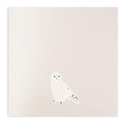 Minimalist Christmas card in pearly white with a simple illustration of a snowy owl.
