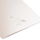 A close-up of a minimalist Christmas card in pearly white with a simple illustration of a snowy owl, matched with a white envelope.