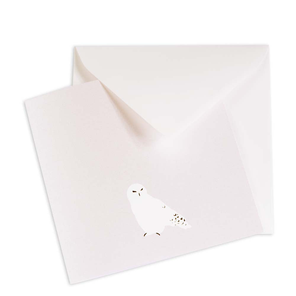 Minimalist Christmas card in pearly white with a simple illustration of a snowy owl, matched with a white envelope.