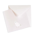 Minimalist Christmas card in pearly white with a simple illustration of a snowy owl, matched with a white envelope.