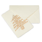 A cream-colored Christmas card with deckled edges, featuring a gold handwritten text design arranged in the shape of a Christmas tree with a small star on top, shown with a matching cream envelope.