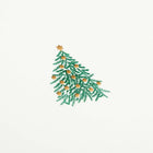 A close-up of a simple white Christmas card with a small decorated Christmas tree illustration in the center.
