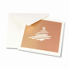 Christmas card on bronze paper with a stylized scribble drawing of a white Christmas tree, paired with a plain white envelope.