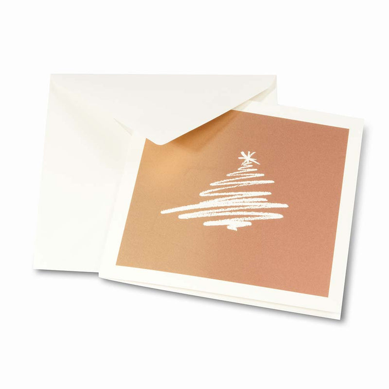 Christmas card on bronze paper with a stylized scribble drawing of a white Christmas tree, paired with a plain white envelope.