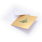 Gold Christmas card with a hand-drawn green Christmas tree illustration in the center, paired with a plain white envelope.