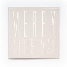 A square cream-colored Christmas card with embossed tall block letters spelling "MERRY CHRISTMAS".