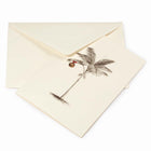 Tropical-themed cream Christmas card featuring a finely sketched palm tree with a single gold ornament hanging from its fronds, paired with a cream envelope.