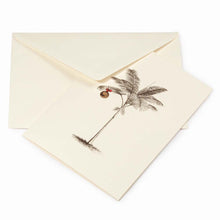 Tropical-themed cream Christmas card featuring a finely sketched palm tree with a single gold ornament hanging from its fronds, paired with a cream envelope.