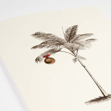 A close-up of a tropical-themed cream Christmas card featuring a finely sketched palm tree with a single gold ornament hanging from its fronds.