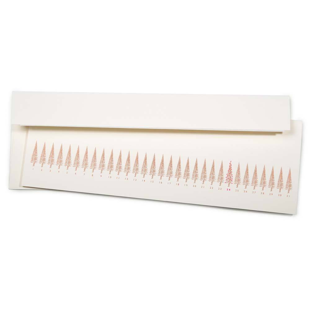 Long, slim Christmas card with a row of stylized gold Christmas trees, numbered like a calendar up to 31. The tree on the 24th is highlighted in red. Comes with a white envelope.
