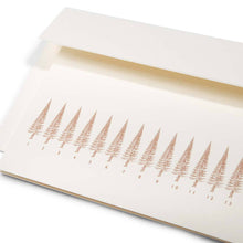 A close-up of a long, slim Christmas card with a row of stylized gold Christmas trees, numbered like a calendar up to 31. The tree on the 24th is highlighted in red. Comes with a white envelope.