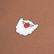 The back of a Christmas card with a cartoon illustration of Santa’s white beard and mustache, with a red tongue playfully sticking out, on a brown background.